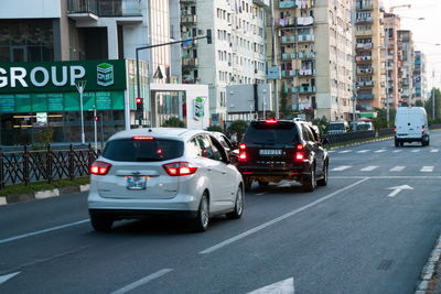 Cars on city street against buildings