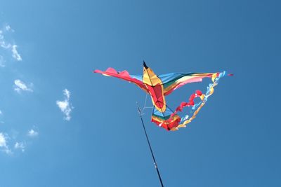 Low angle view of kite against clear blue sky