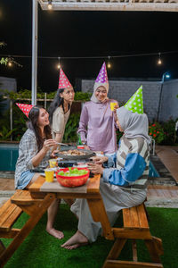 Portrait of smiling friends sitting at restaurant