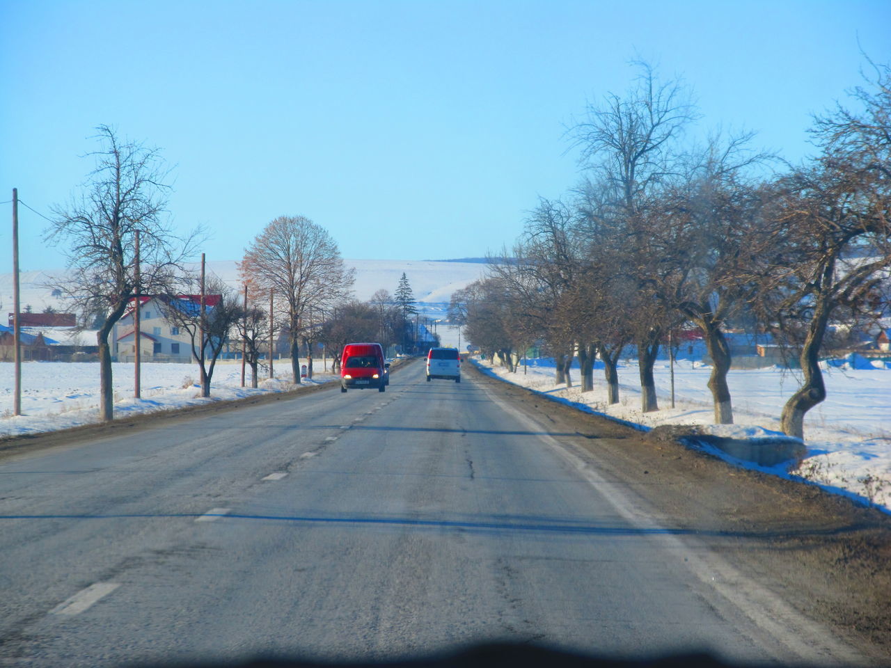 REAR VIEW OF MAN ON ROAD IN WINTER