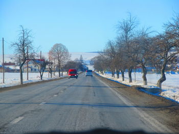 Rear view of man on snow covered road