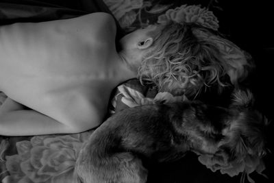 Close-up of cat sleeping on bed at home