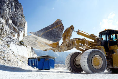 Excavator in massa carrara marble mines