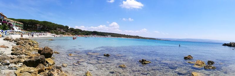 Panoramic view of beach against blue sky