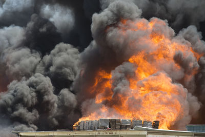 Smoke emitting from burning crates in factory