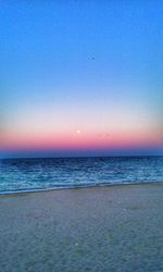 Scenic view of sea against clear sky at sunset