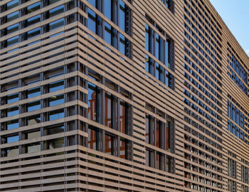 Low angle view of modern building in city against sky