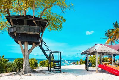 Built structure on beach against blue sky