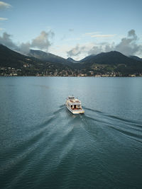 Boat on the lake at sunset with mountains in the background