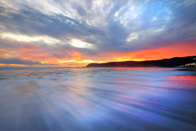 Scenic view of sea against dramatic sky