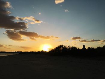 Scenic view of silhouette field against sky during sunset