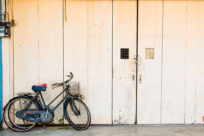 Bicycle parked against building