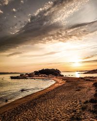 Scenic view of beach against sky during sunset