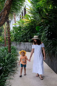 Mother and son walking on hotel pathway