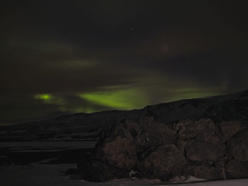 Scenic view of mountains against sky at night