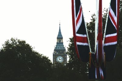 Low angle view of flags with buildings in background