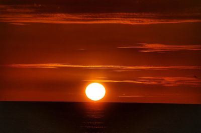 Scenic view of sea against romantic sky at sunset