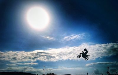 Low angle view of silhouette man against sky