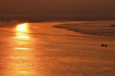 Scenic view of beach against sky during sunset