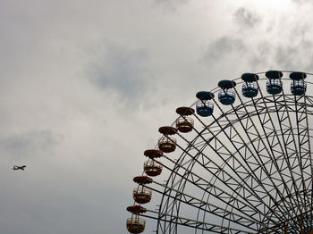 Low angle view of ferris wheel against sky