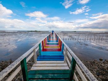 Pier over sea against sky