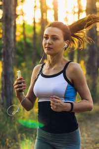 Young woman using mobile phone outdoors