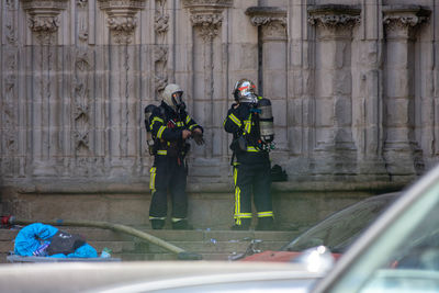 People working in front of building