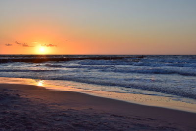 Scenic view of sea against clear sky during sunset
