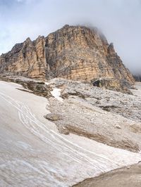 Misty peak of sasso di landro, massive tre cime di lavaredo rocks, dolomites in italy