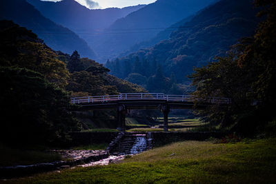 Bridge over mountains against sky