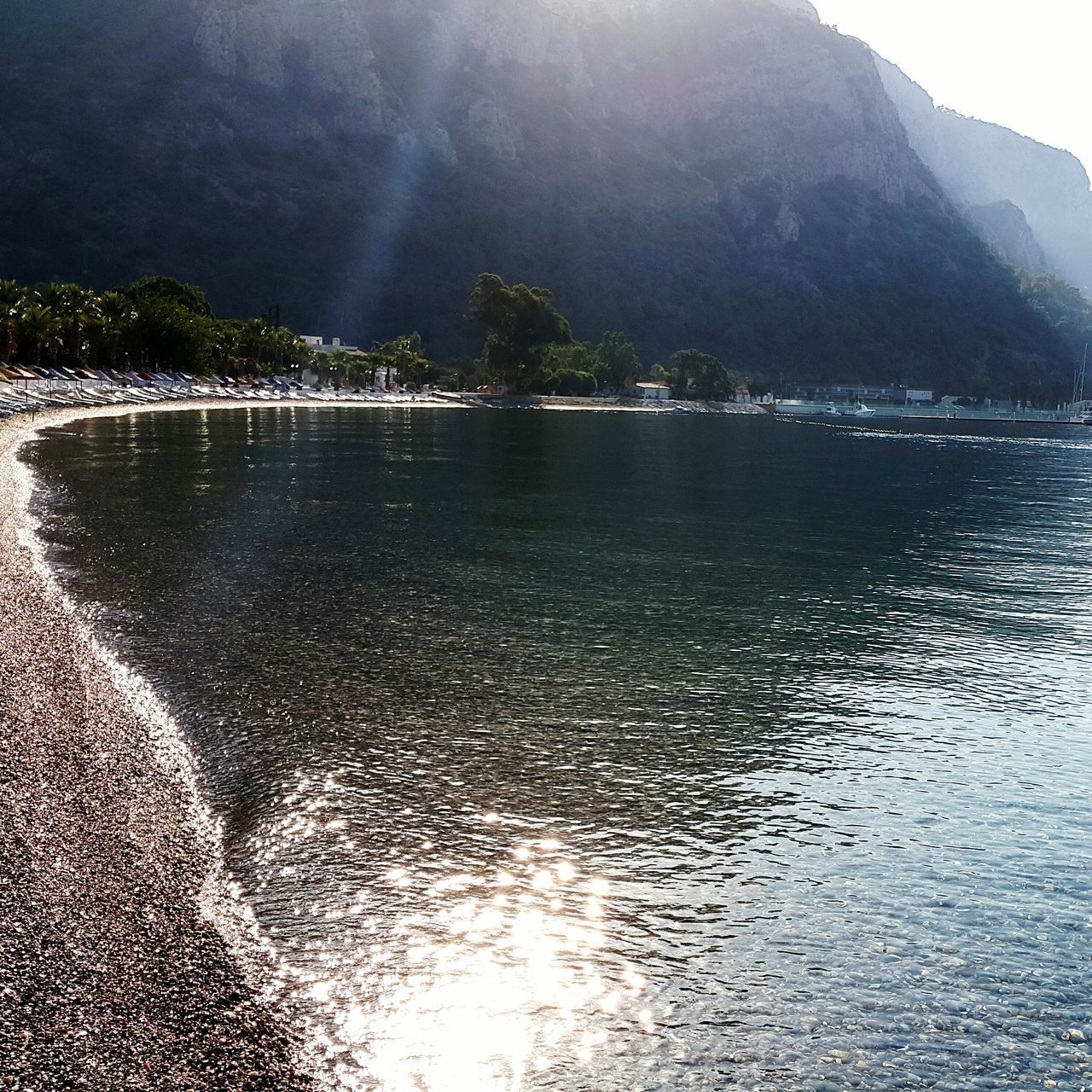 water, scenics, tranquil scene, waterfront, tranquility, beauty in nature, nature, sky, lake, mountain, reflection, rippled, river, sea, idyllic, tree, remote, outdoors, non-urban scene, day