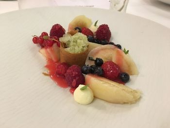 High angle view of fruits in plate on table