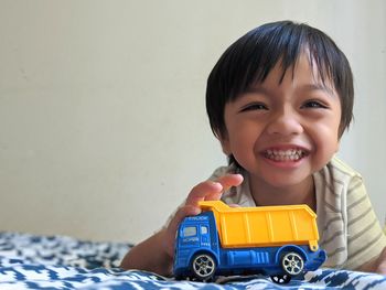 Portrait of happy boy with toy car