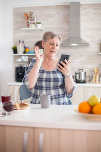 Woman talking on video call at home