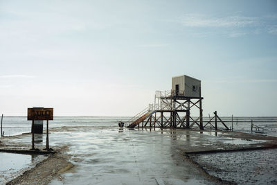 Lifeguard hut on beach against sky