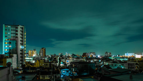 View of cityscape against cloudy sky