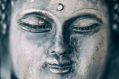 Close-up portrait of man with sculpture