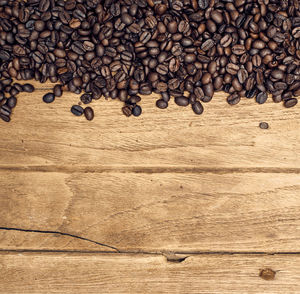 Directly above shot of roasted coffee beans on wooden table