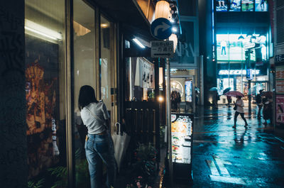 Man walking in illuminated city at night