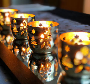 Close-up of illuminated tea light candles on table