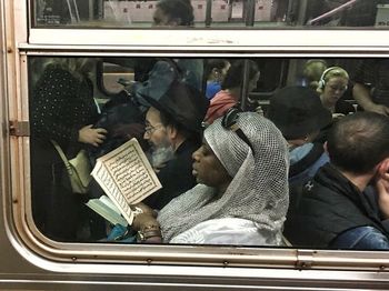 Man sitting on train window