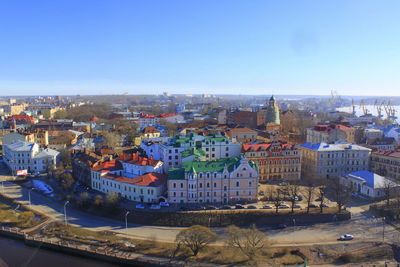 High angle view of cityscape against clear blue sky