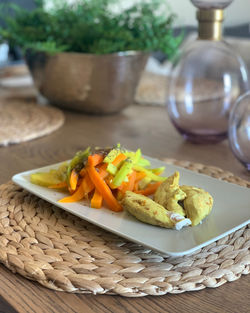 Healthy food with chicken meat and vegetables on wooden table