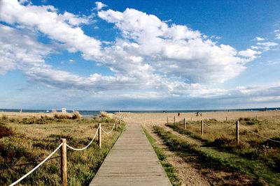 View of wooden fence on field against sky