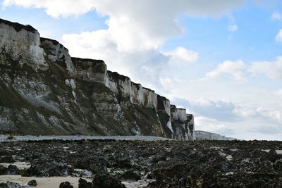 Low angle view of rock formations against sky