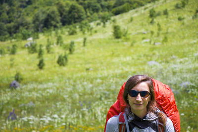 Hiker and backpacker in the mountain valley and field, trekking and hiking scene 