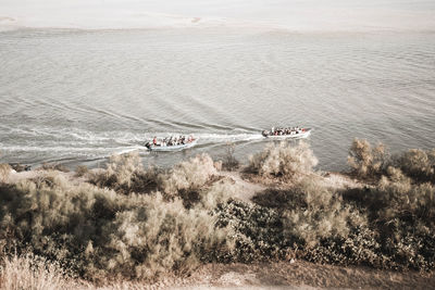 High angle view of people on boats in sea