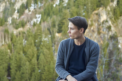 Man sitting against trees