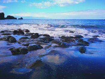 Scenic view of sea against blue sky