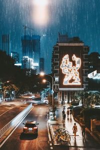 Cars on city street at night